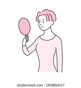 
A woman smiling while looking at a hand mirror