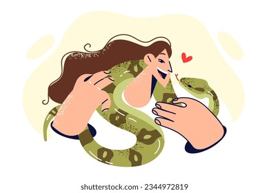 Woman with snake around neck smiles and looks at green python, rejoicing at presence of beloved pet. Girl owner of domestic snake enjoys communication with poisonous reptile capable of stinging