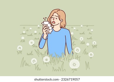 Woman sneezes because of allergy caused by dandelion blossoms and pollen from summer plants. Unhappy girl with handkerchief needs allergy medicine to stop irritation of mucous membranes of nose.