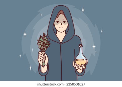 Woman sorceress dressed in cloak with hood holds miraculous elixir and sprig of plant. Healer girl prepared for mysterious rite using magic or healing conspiracy