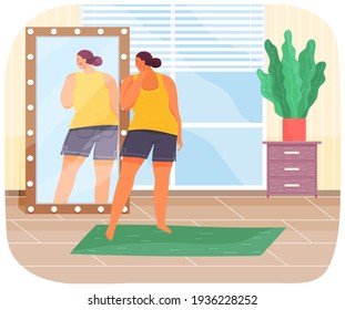 Woman in sportswear looking at reflection in mirror. Unhappy plump girl standing in front of mirror