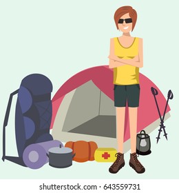 woman standing with camping and hiking gear