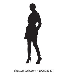 Woman standing in coat and in high heels shoes with hands in her pockets, isolated vector silhouette