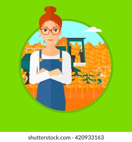 Woman standing with combine on background.