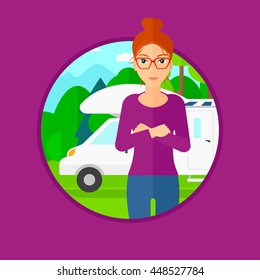 Woman standing in front of motor home. Woman with arms crossed enjoying vacation in camper van. Woman travelling by camper van. Vector flat design illustration in the circle isolated on background.