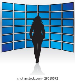 A Woman Standing In Front Of A Wall Of Widescreen LCD Or Plasma TV Screens.