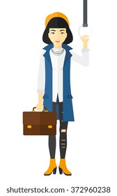 Woman standing inside train.