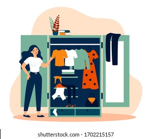 Woman standing near opened closet and looking at dresses flat vector illustration. Pile of clothes laying in wardrobe. Organization and arrangement concept.