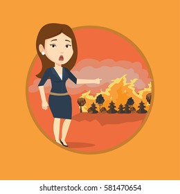 Woman standing on the background of a big forest fire. Woman pointing at forest in fire. Concept of environmental destruction. Vector flat design illustration in the circle isolated on background.