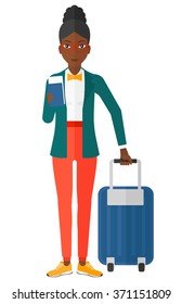 Woman standing with suitcase and holding ticket.