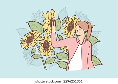 Woman stands in field with sunflowers enjoying nature and organic plants grown without use of pesticides. Sunflowers flowers near girl who owns agricultural plantation or agro farm