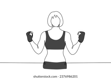 woman stands with her arms bent at the elbows, demonstrating her muscles, she is wearing gloveletts, boxers and a sports bra