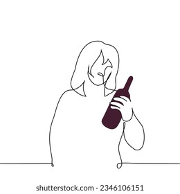 woman stands holding a bottle of wine in her hand and reading the label - one line art vector. concept wine lover, wine alcoholic, customer in wine store
