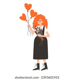 A woman stands and holds red balls in the shape of hearts for Valentine's Day