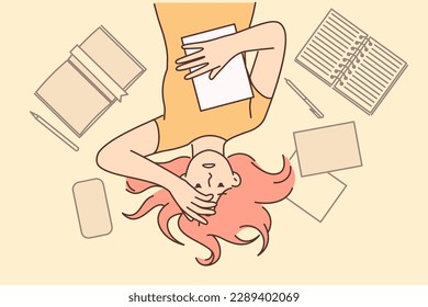 Woman student worry about upcoming exams at university or college lying on floor among textbooks. Girl student or office worker clutching head after experiencing burnout associated with overload