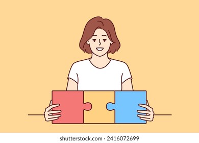 Woman successfully connects pieces of mazaik symbolizing planning in career or personal life. Smiling girl demonstrates puzzle design, announcing presence of planning system in business