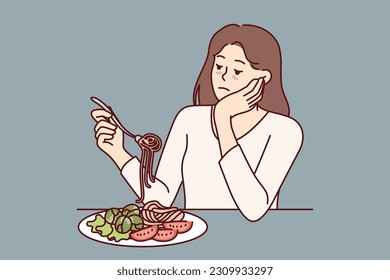 Woman suffering from anorexia is sad due to lack of appetite and sits at table with spaghetti and salad in plate. Skinny girl with sickly appearance suffers from anorexia after wrong diet