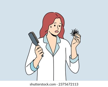 Woman suffering from baldness or hair loss problems holds comb and feels confused and needs help of doctor. Girl in pajamas saw hair falling out and thought about buying new shampoo.