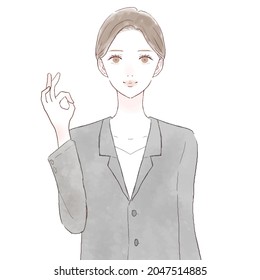 Woman in suit with OK sign. On white background.