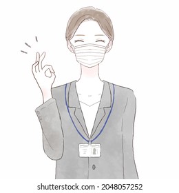 Woman in suit wearing nonwoven mask with OK sign. On white background.