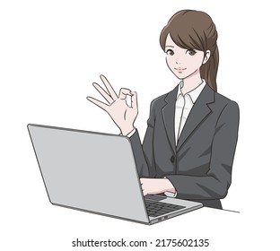 A woman in a suit who makes an OK mark in front of a PC