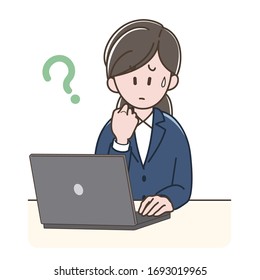 A woman in a suit worried looking at the PC