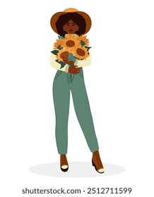 Mujer con girasoles. Mujer afroamericana con traje de otoño y sombrero.