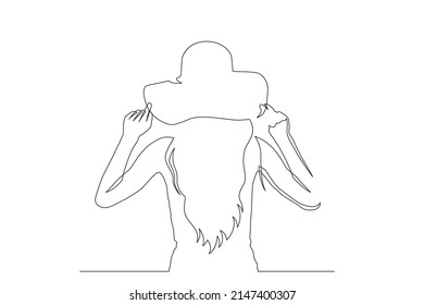 Woman in sunhat on a beach illustration continuous line drawing. Vector illustration.