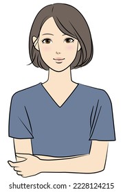 A woman in surgical clothes who folds her arms