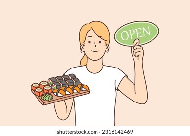 Woman with sushi and rolls on tray holds sign openly inviting to visit japanese restaurant. Young girl invites you to order sushi or rolls in cafe with door-to-door delivery service.