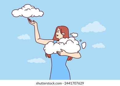 Woman takes clouds from sky, enjoying clear weather and fresh air available thanks to clean environment. Young girl seeing wonderful dream about opportunity to hold clouds with firmament in hands