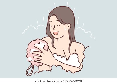 Woman takes shower using washcloth and stands among foam enjoying hygiene procedures with good bathing gel. Girl with bare shoulders bathes to advertise quality hygiene products for use in shower 