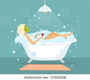 Woman in taking a bubble bath in a vintage bathtub, relaxing, drinking wine, making facial mask