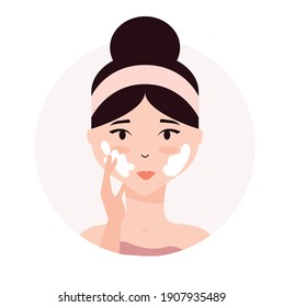 Woman taking care of her face. Daily skincare routine. Young woman applying facial cream to her face . Skin hydration, moisturizing