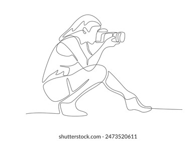 Woman taking photos while squatting. World photography day concept one-line drawing