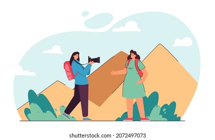 Woman taking picture of her friend on pyramids background. Two female characters travelling together flat vector illustration. Adventure, tourism concept for banner, website design or landing web page