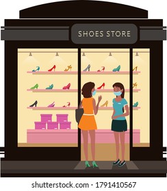A woman talking to the sales woman at shoes store