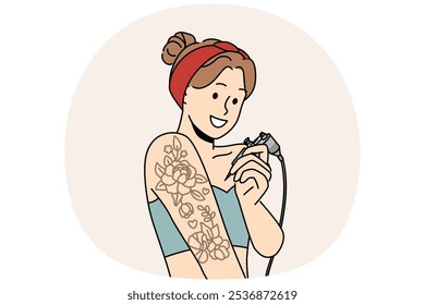 Tatuajes de mujer mano a mano y sonrisas, ofreciendo el uso de servicios de artista profesional del tatuaje. Muchacha joven que trabaja en el salón del tatuaje sostiene el equipo para dibujar la imagen debajo de la piel con la aguja.