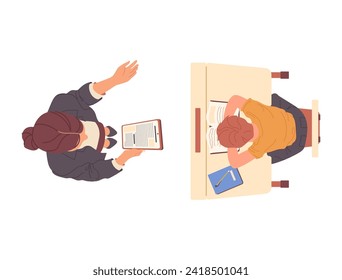 Woman teacher reading dictation for schoolboy child writing in copybook sitting at desk top view