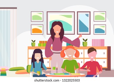 woman teacher teaching boys and girls preschool modern kindergarten children classroom with desk colorful furniture kid room interior portrait closeup flat horizontal