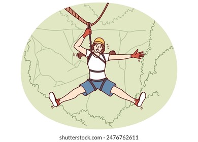Woman tourist hangs on zip line over forest cliff enjoying extreme vacation in picturesque place. Tourist girl descends from mountain on rope getting adrenaline from adventures while traveling