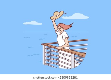 Woman tourist on cruise liner stands near side and waves hand rejoicing at summer travel across ocean. Happy girl rejoices in freedom and opportunity to travel on sea yachts between tropical islands
