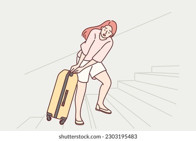 Woman tourist pulls travel suitcase up stairs at train station or airport, concept of uncomfortable urban environment. Girl tourist with heavy suitcase goes on long journey or expedition