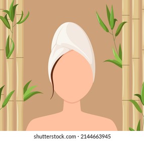 A woman with a towel on her head against a bamboo background. Spa treatments. Taking care of your body.