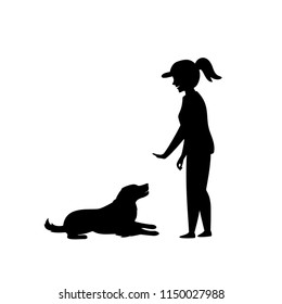 woman training a dog basic commands silhouette