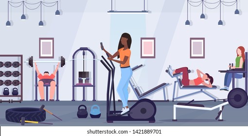 woman training on stepper treadmill african american girl using smartphone while working out digital gadget addiction concept modern gym studio interior flat full length horizontal