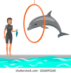 Woman Trains Dolphin In Dolphinarium. Dolphin Showing Trick, Jumping Through Hoop In Pool. Training, Show With Marine Animals In Oceanarium. Trainer Feeds Animal With Fish For Trick Performance