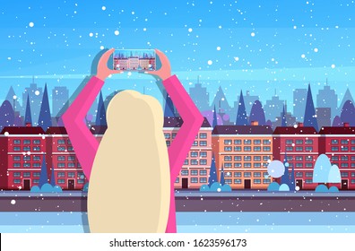 woman traveler photographing town buildings on smartphone camera traveling blogging concept rear view tourist sightseeing architecture modern winter city street horizontal portrait vector illustration