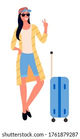 Woman traveler with suitcase on wheels, showing peace sign vector. Baggage or luggage, girl in glasses and cap, summer vacation or holidays, traveling