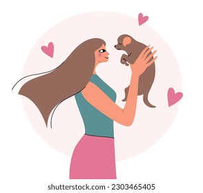 Woman in a trendy style holding a puppy. Girl and her pet.